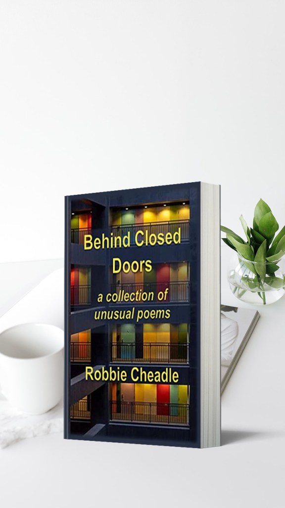 A print copy of Behind Closed Doors on a white desk.