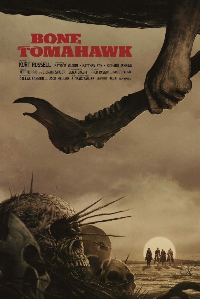 Movie Poster: Four men on horseback coming forward on the prarie landscape in the distance framed by a large moon on the horizon behind them, with skulls on the ground in the forefront and a hand hanging down from the top of the frame holding a tomahawk made from a jawbone.
Text: Bone Tomahawk, Starring Kurt Russell, Also starring Patrick Wilson, Mathew Fox, Richard Jenkins, Music by Jeff Herriot and S. Craig Zahler, etc...