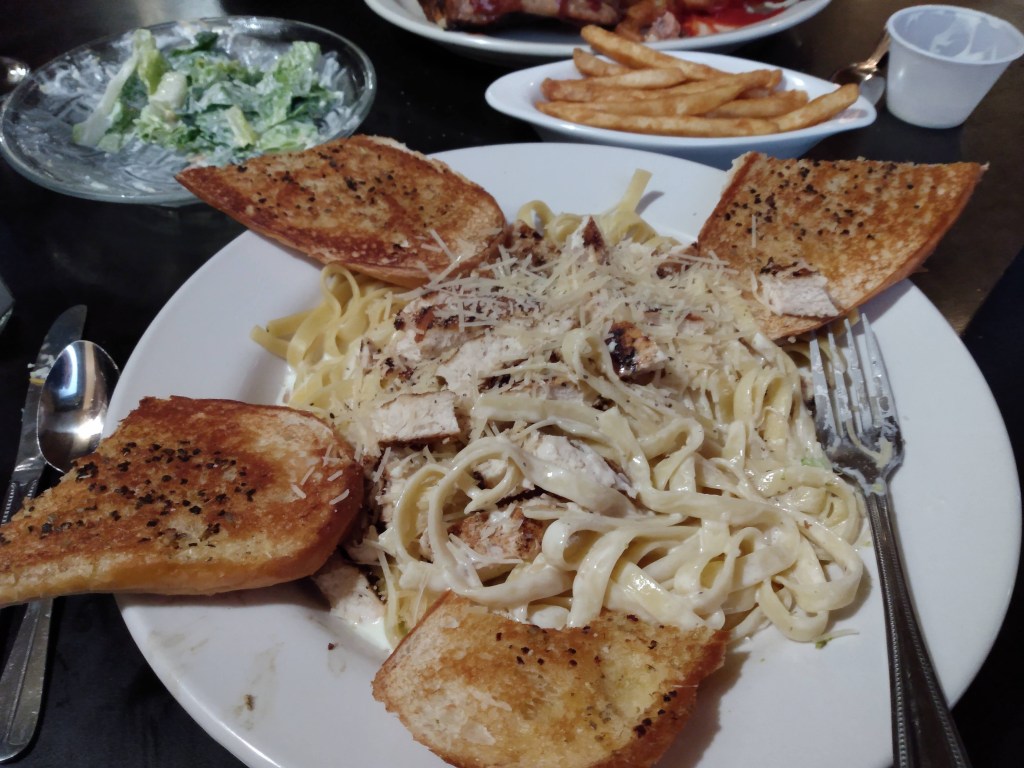Photo of a plate of shrimp fettucini and garlic bread