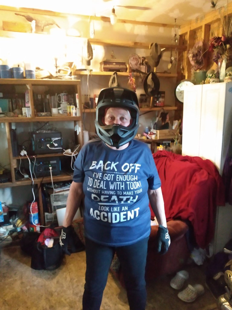 Kaye Lynne Booth in a blue shirt and helmet - Ready to ride