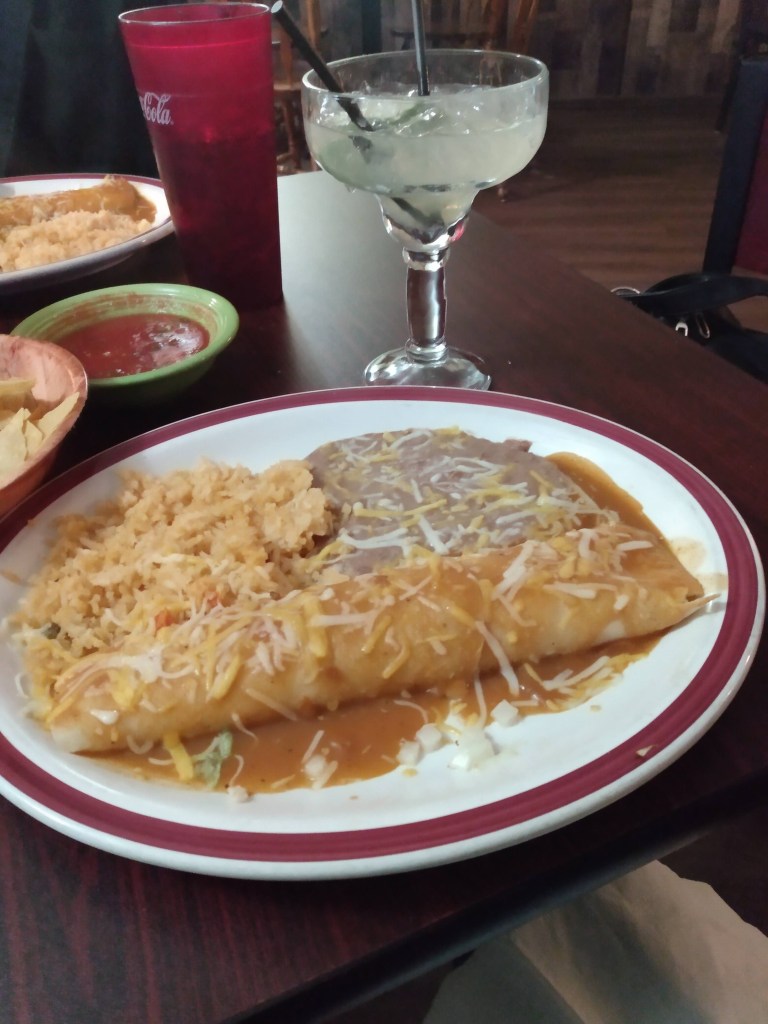 Enchilada with spanish rice and beans