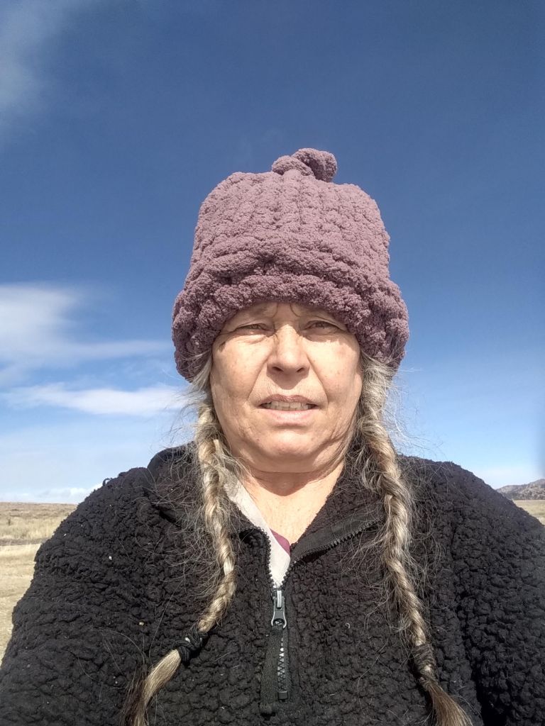 A purple crocheted hat